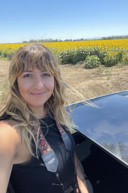 Jessica smiling while visiting a flower pasture in California.