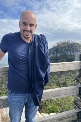 Mike poses in front of a mountain range in Wyoming.