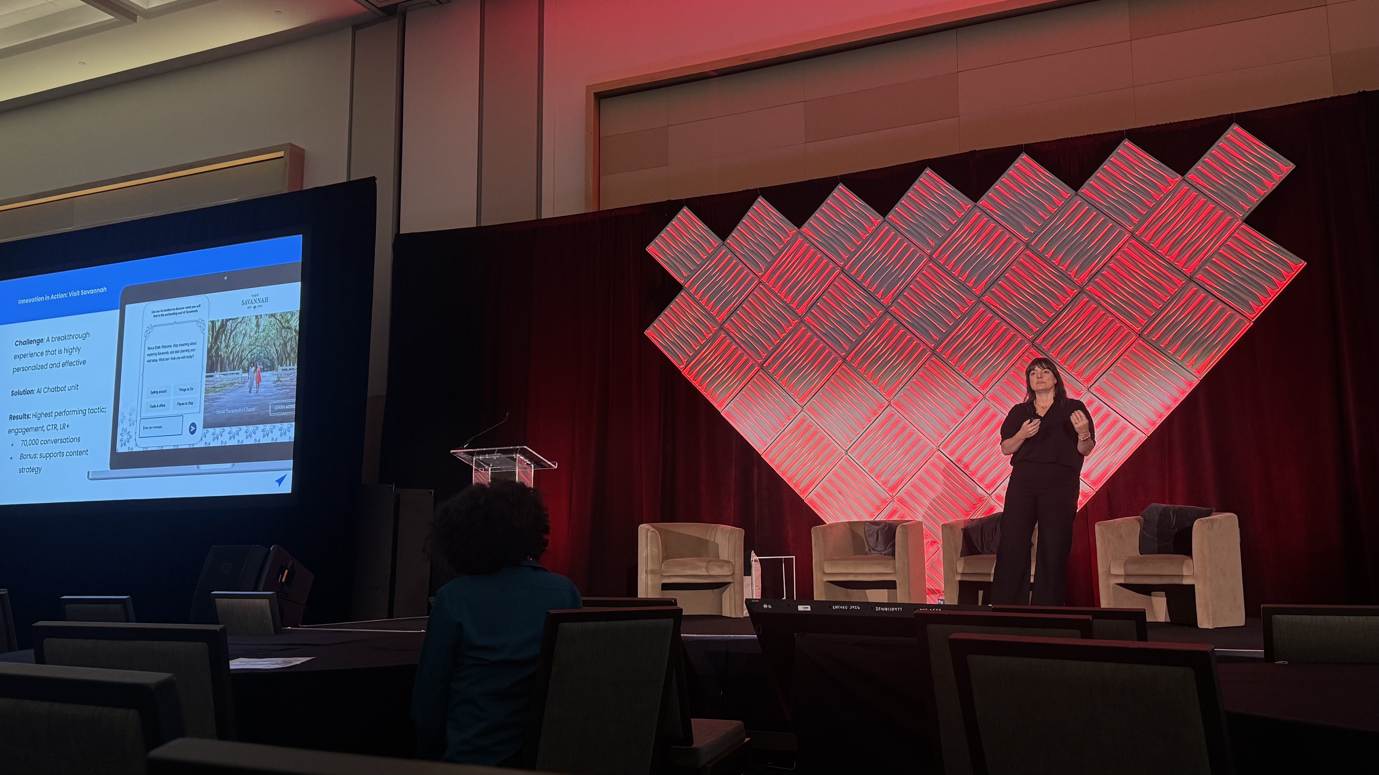 A photo of Susan presenting on stage. 