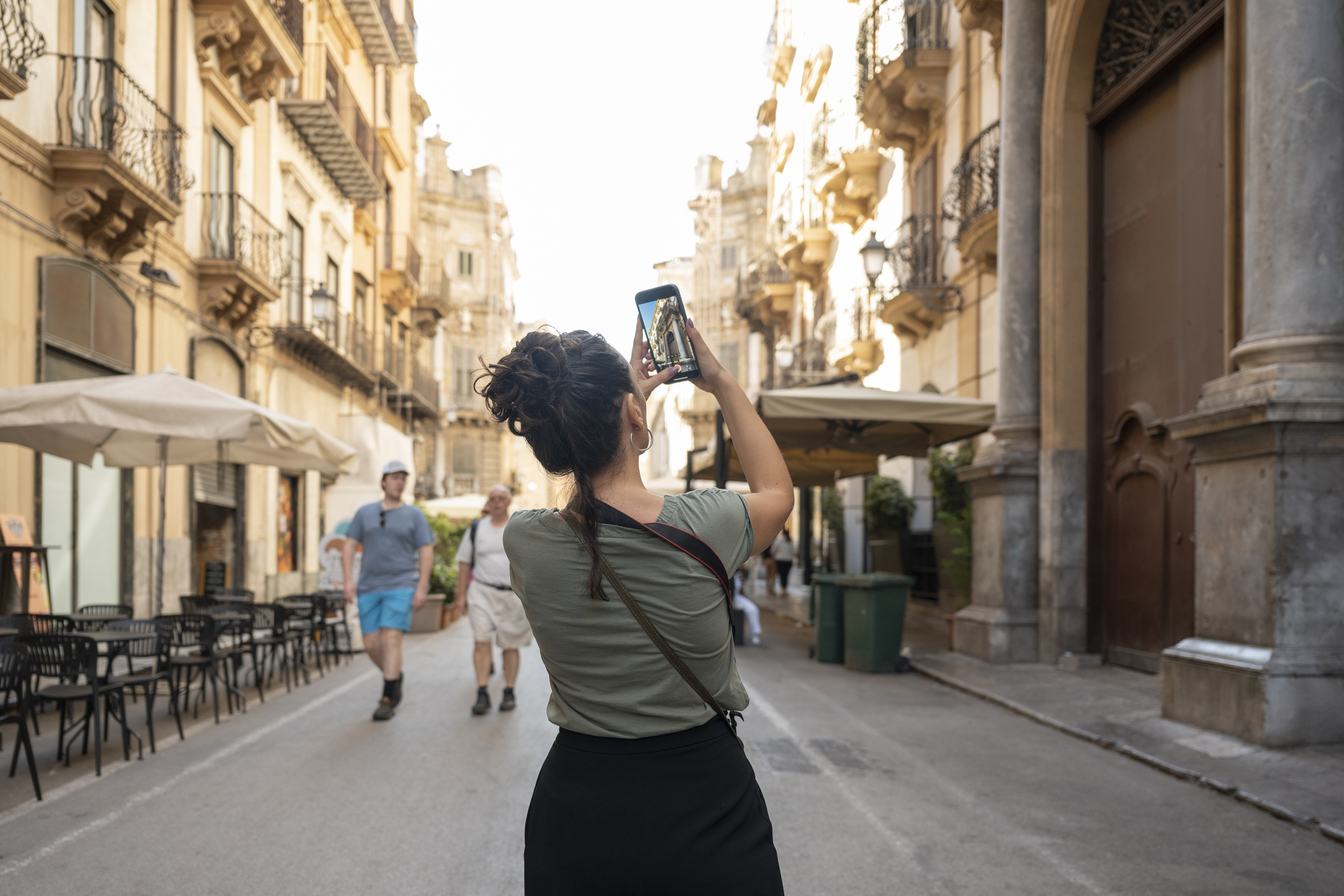 A tourist taking a photo of a landmark. 