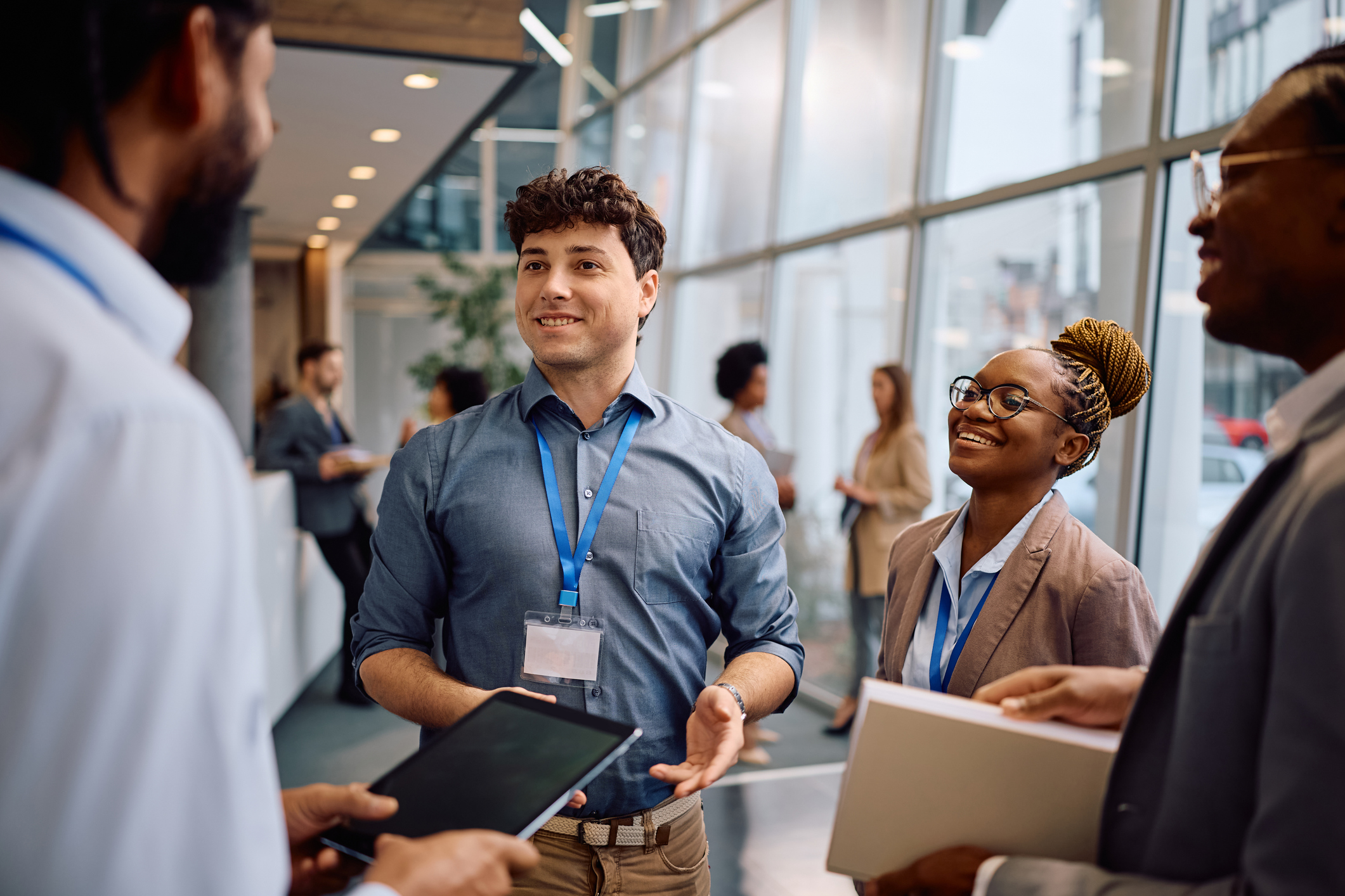 A photo of a smiling man in a business setting. 