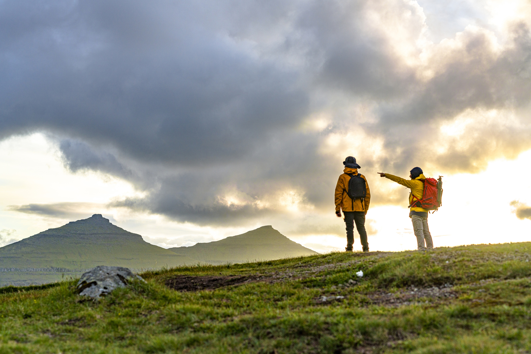 Hikers pointing at an upcoming storm. 
