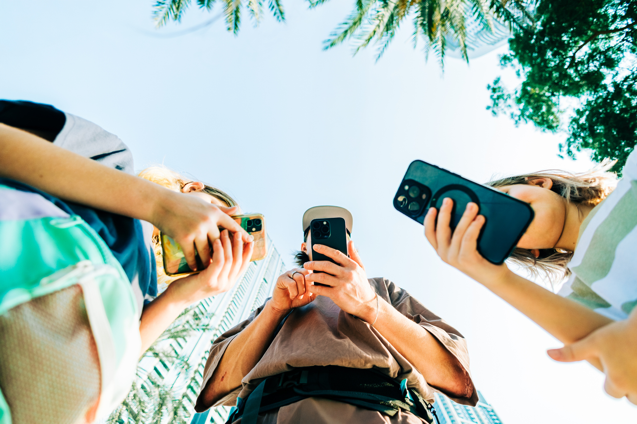 Low angle photo of travelers on their phones. 