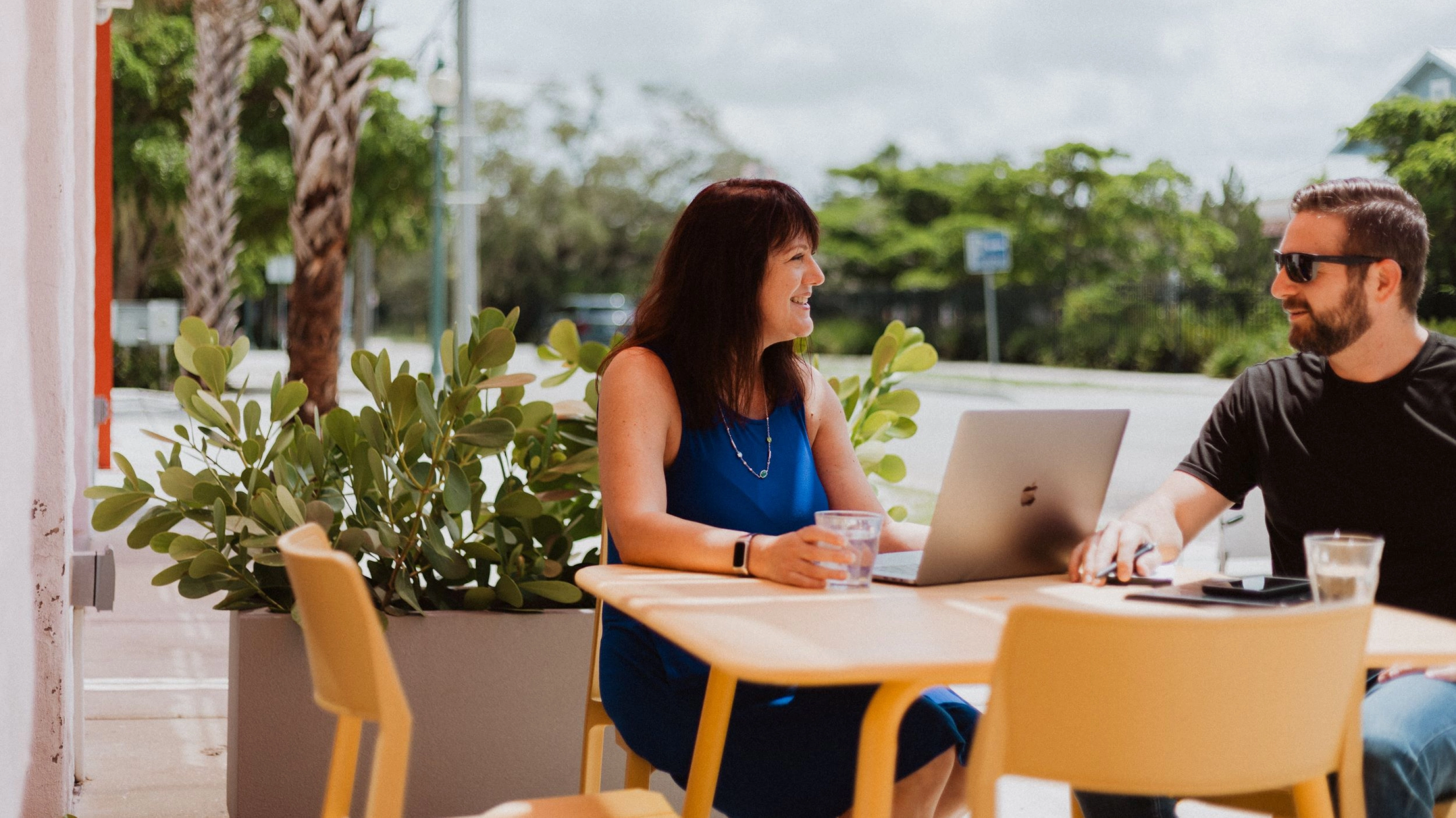 A photo of Kim Palmer and Neal Alfano chatting outside a shop. 