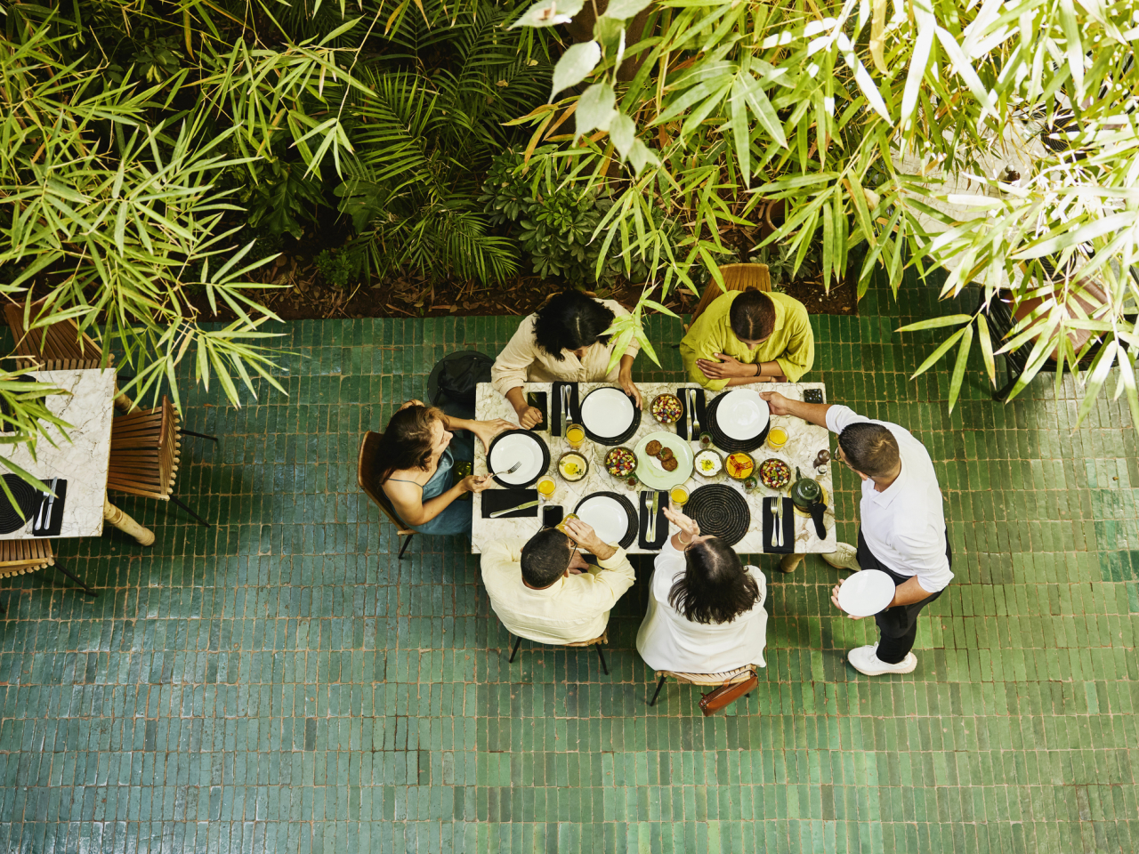 Overhead view of a group of people sharing food at a table