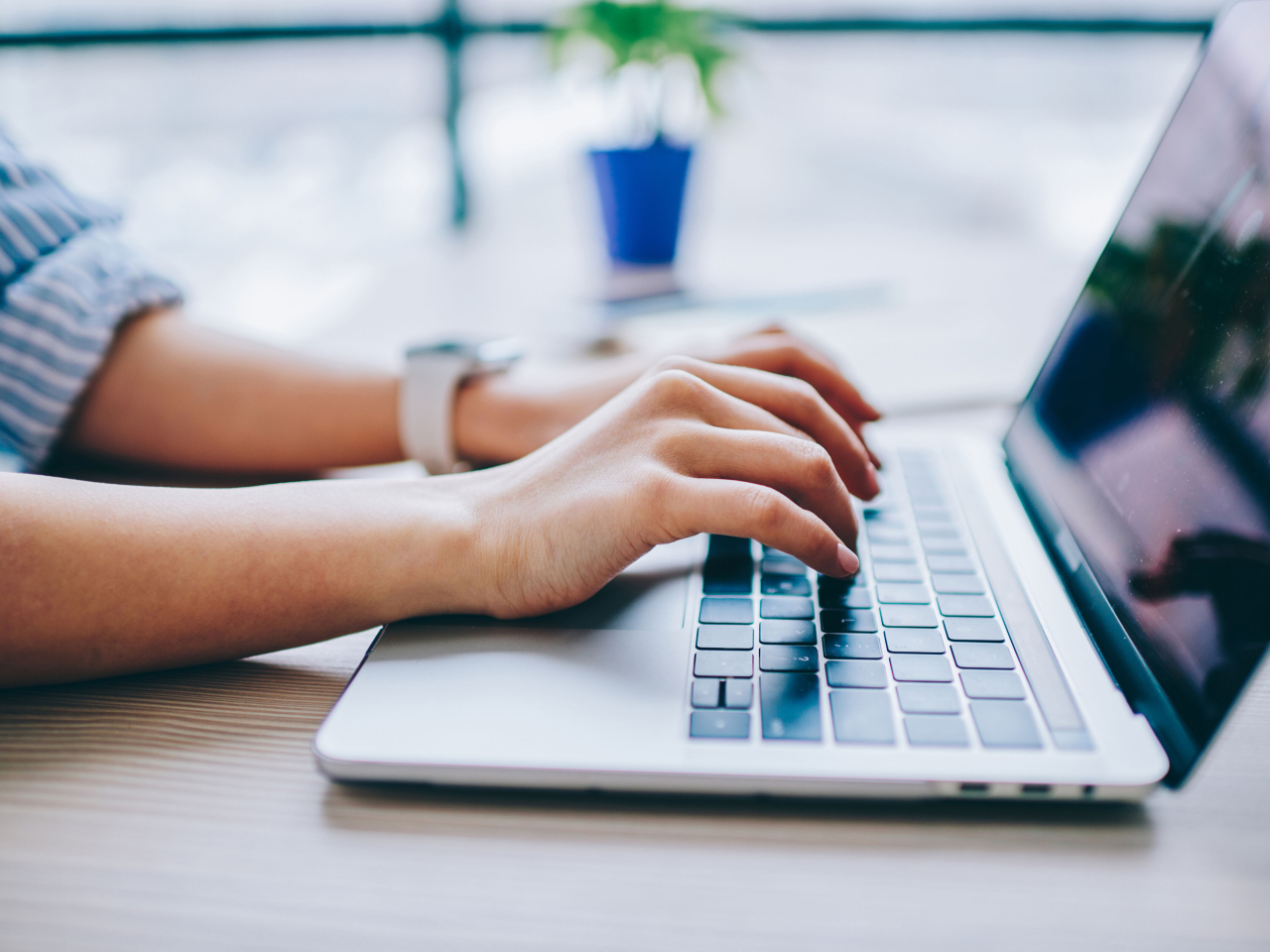 A person typing on their laptop. 