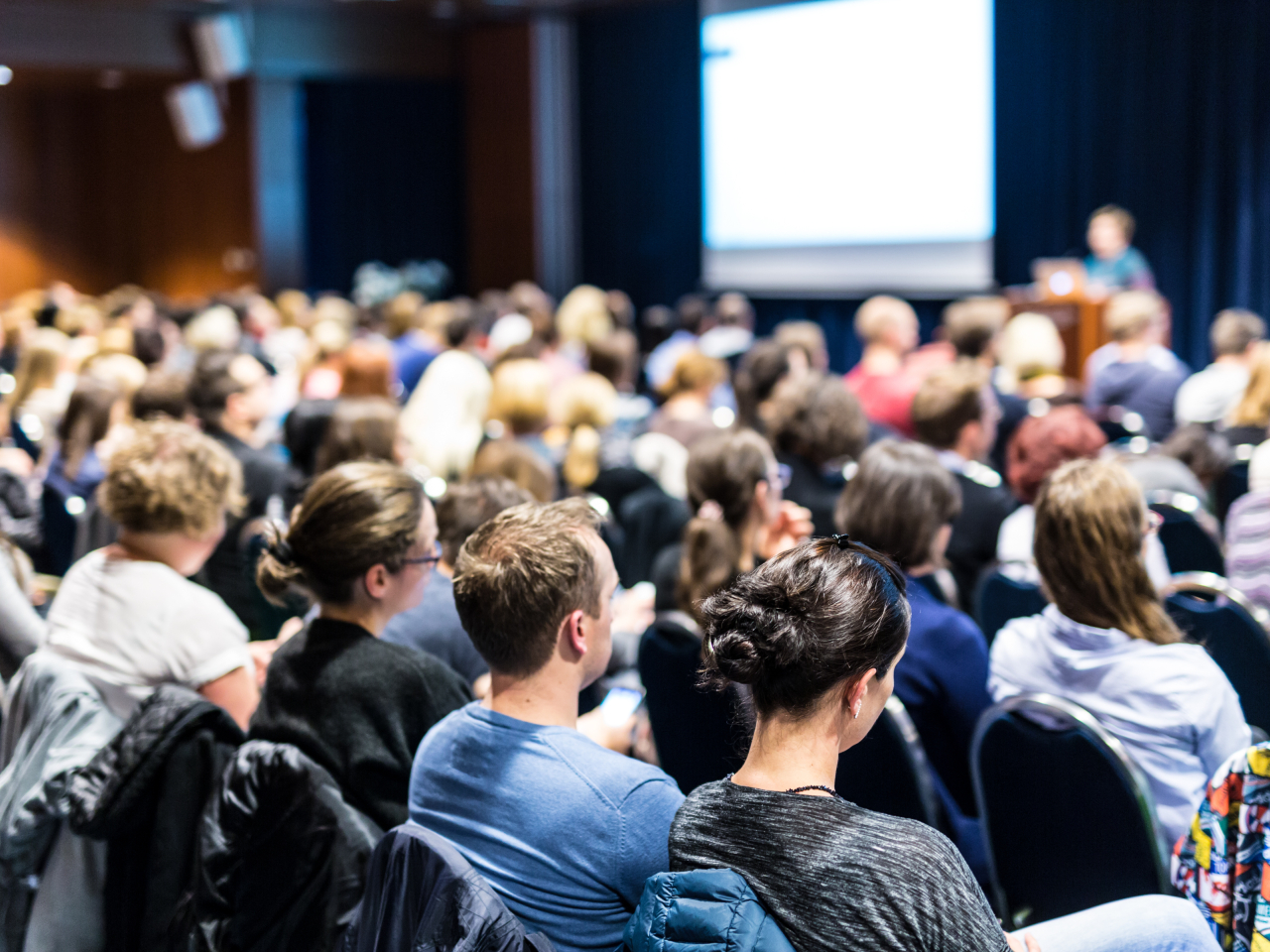 A sea of attendees at a conference. 