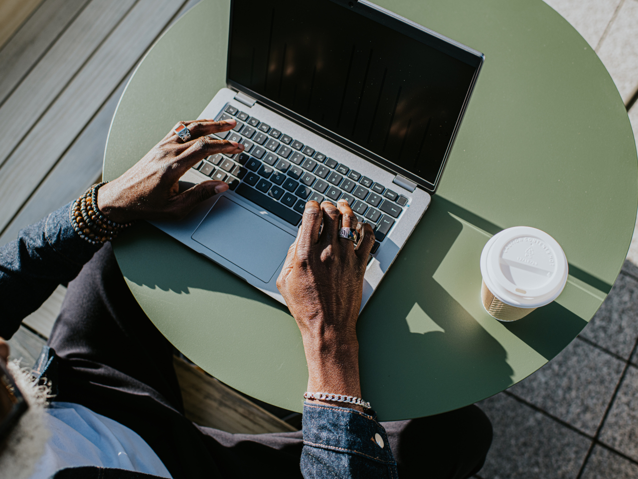 An aerial photo of someone typing on a laptop. 