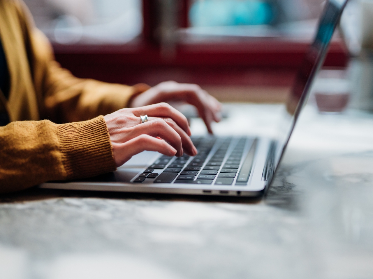 A photo of hands on a laptop. 