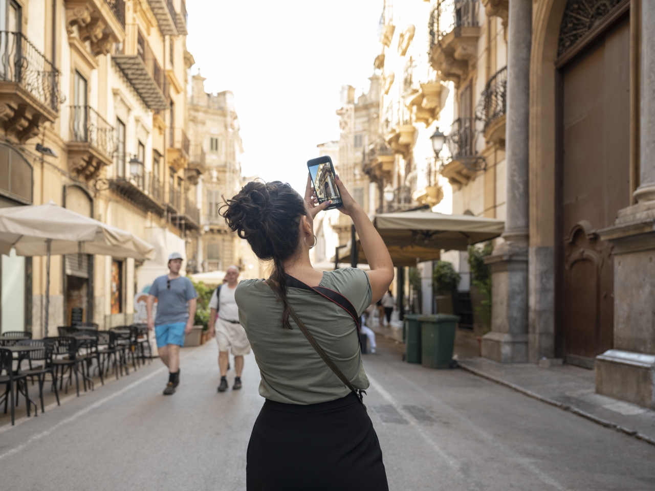 A tourist taking a photo of a landmark. 