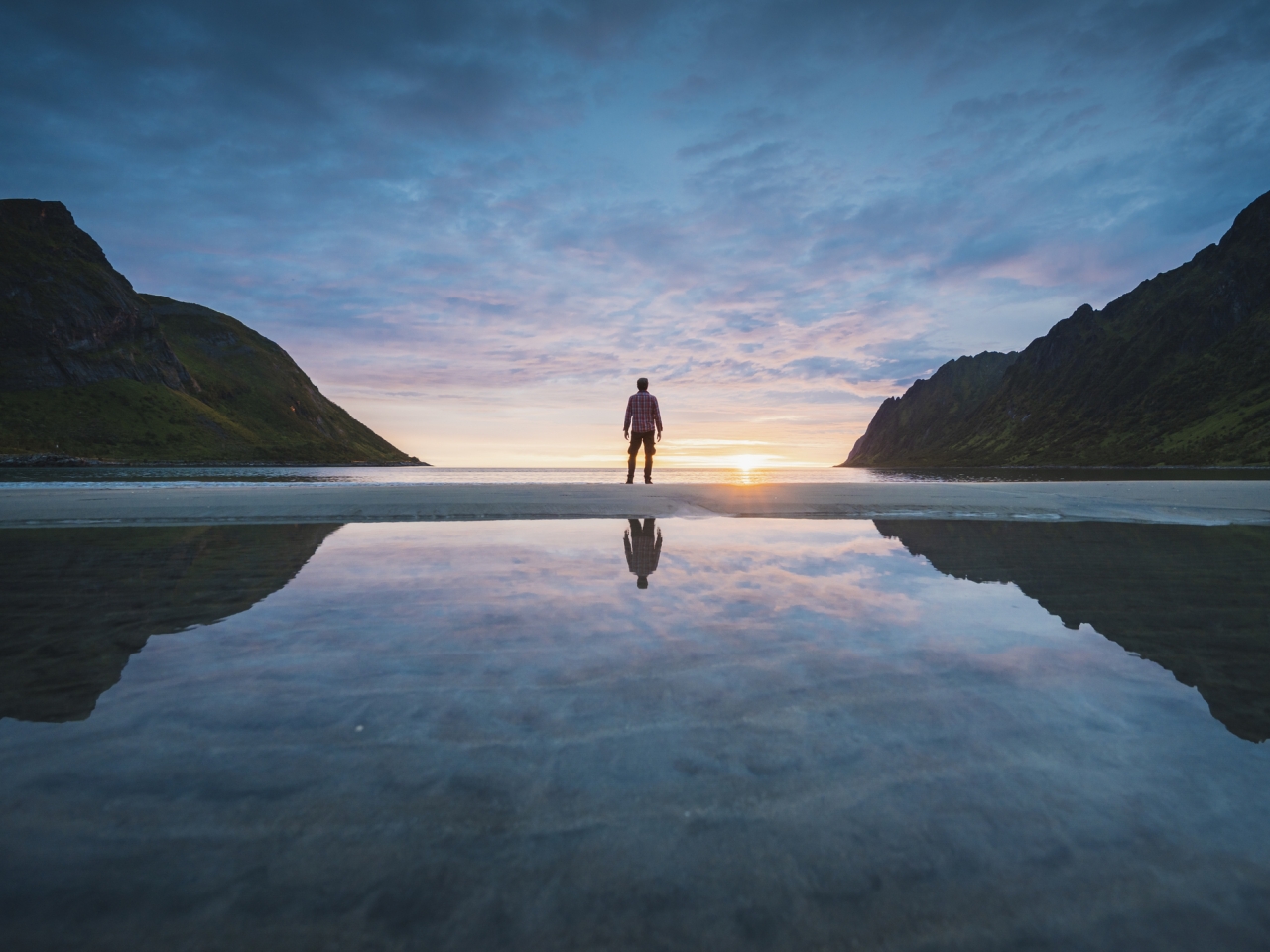 A photo of a man in between two mountains. 