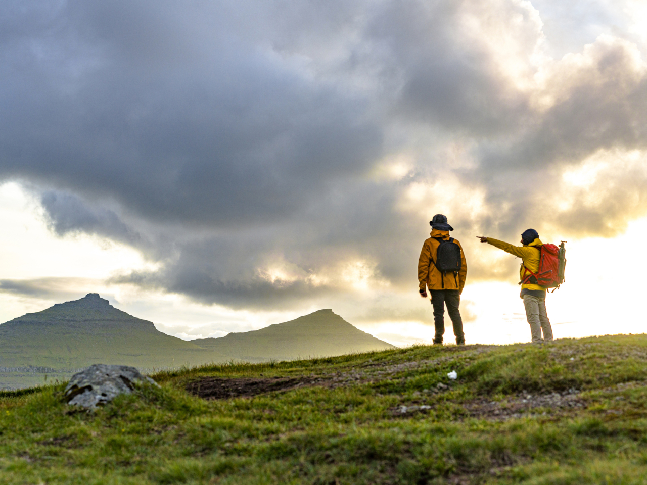 Hikers pointing at an upcoming storm. 