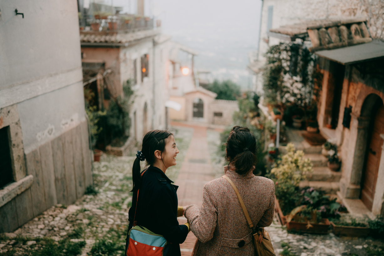 Mother and daughter walking through an Italian village