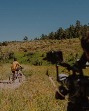 an image of a man recording someone on a bicycle