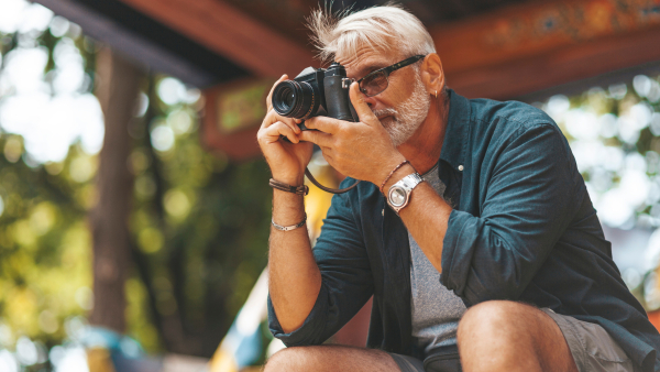 A senior traveler taking a photo. 