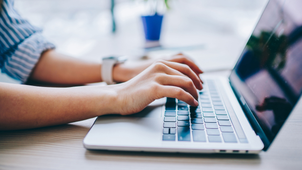 A person typing on their laptop. 