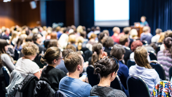 A sea of attendees at a conference. 