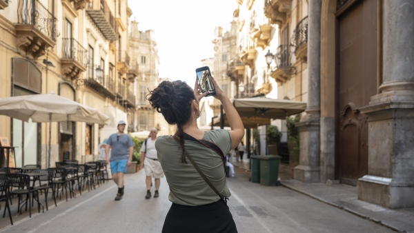 A tourist taking a photo of a landmark. 