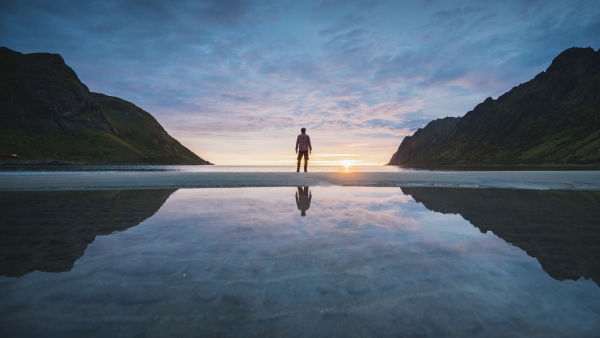 A photo of a man in between two mountains. 