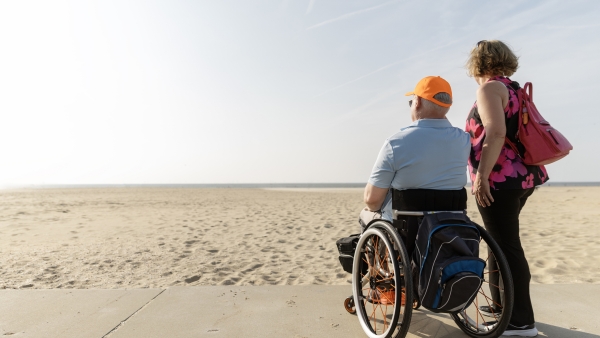 An older couple on the beach. 