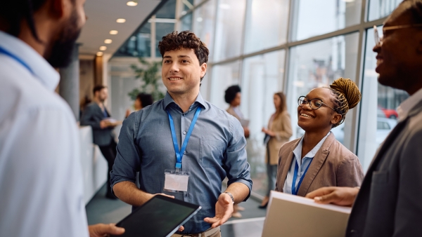 A photo of a smiling man in a business setting. 
