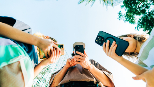 Low angle photo of travelers on their phones. 