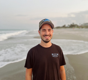 Luke Neumann on a beach