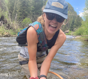 Mattie Hall shows off a rainbow trout she netted in Montana