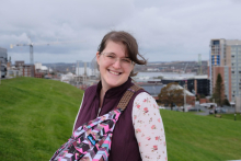 A photo of Katie with a city backdrop