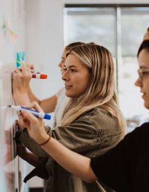 Miles team working at white board
