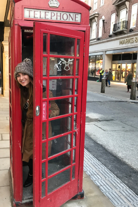 Jordan Kuglitsch inside a red phone booth in London, England