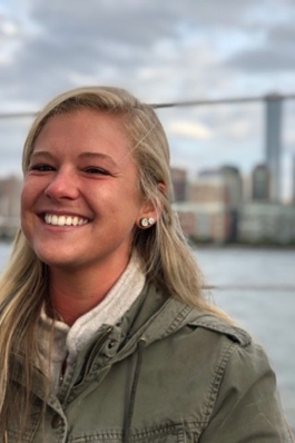 Alyssa Patton with a river and New York City behind her