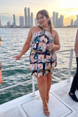 Amanda Curtiellas on a boat with tall city buildings in the background