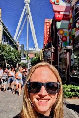 Amanda Steward on a boulevard full of bright colored buildings and shoppers