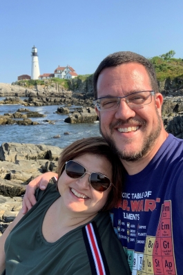 Andrea Ticola in front of lighthouse on a rocky shore