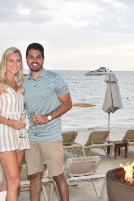 Andrew Cantrell next to a fire pit at a beachside resort