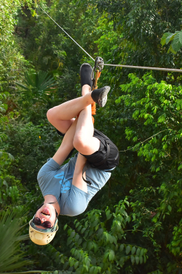 August Erickson hangs upside down while ziplining in Tulum, Mexico