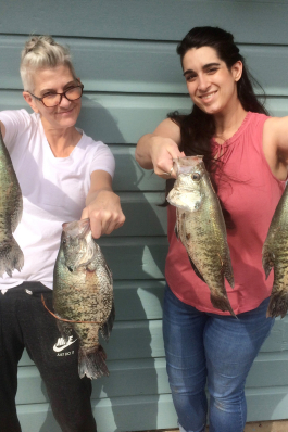 Caitlin Bussey poses with fish she caught