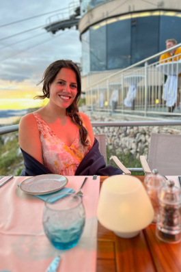 Cara Bettinger sits at a table at the top of the Dubrovnik cable car
