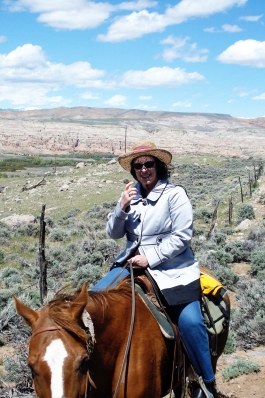 Carrieann Stutz rides a horse in Wyoming