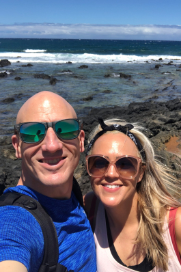 Christine Johnson in front of the rocky shoeline on Kauai
