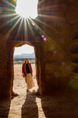 Elena Prostova looks into a doorway at Hegra near AlUla, Saudi Arabia