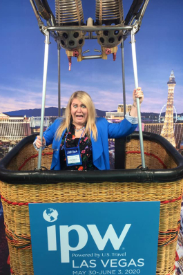 Kiki Mannear poses inside a hot air balloon's basket at a photo opp in Las Vegas