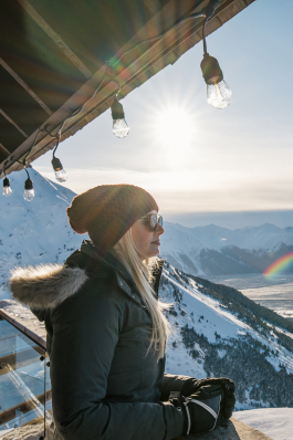 Liz Mabe looks out over ski resort scenery in Alaska