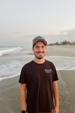 Luke Neumann on a beach