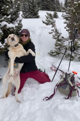Mattie Hall playing in the snow with her dog in Breckenridge, CO