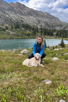 Mattie Hall with her dog at a lakeside in Vail, CO