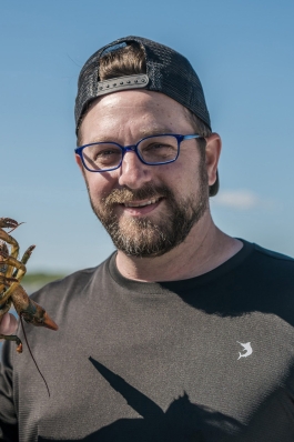 Neal Alfano holds a lobster in Maine