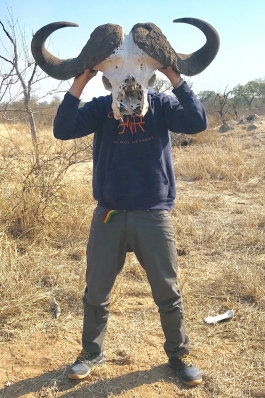 Pat Attkisson holds a bison skull in front of his face like a mask