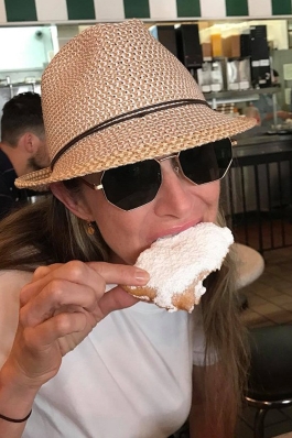 Susi Robichaux takes a bite out of a beignet at Cafe Du Monde in New Orleans